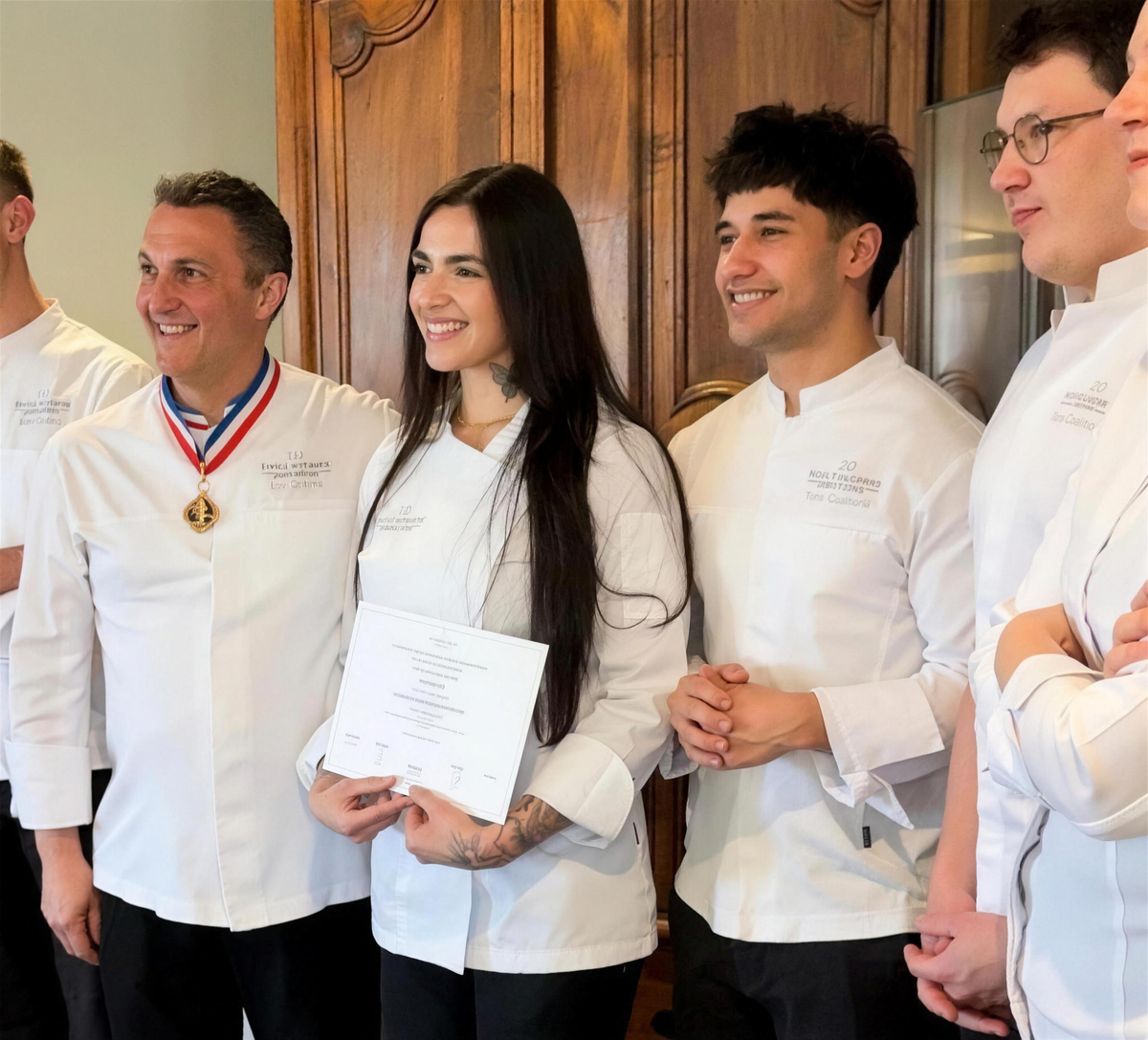 Nanette receiving her pastry diploma in Paris alongside her chef instructors